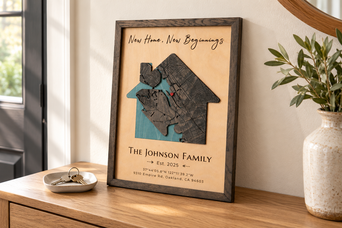 Personalized house-shaped wooden map in an oak frame on an entryway console beside house keys.