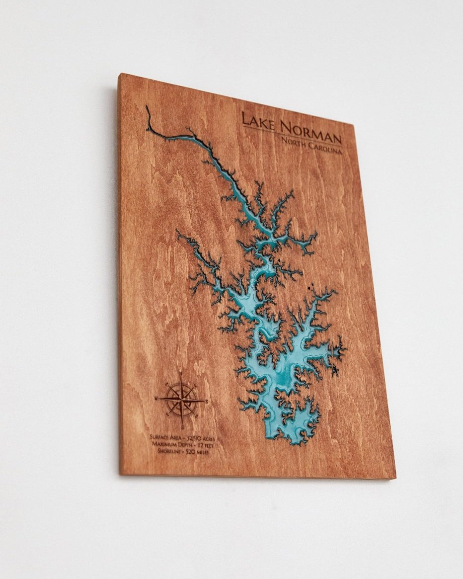 Wooden map of Lake Norman with turquoise water on a white background