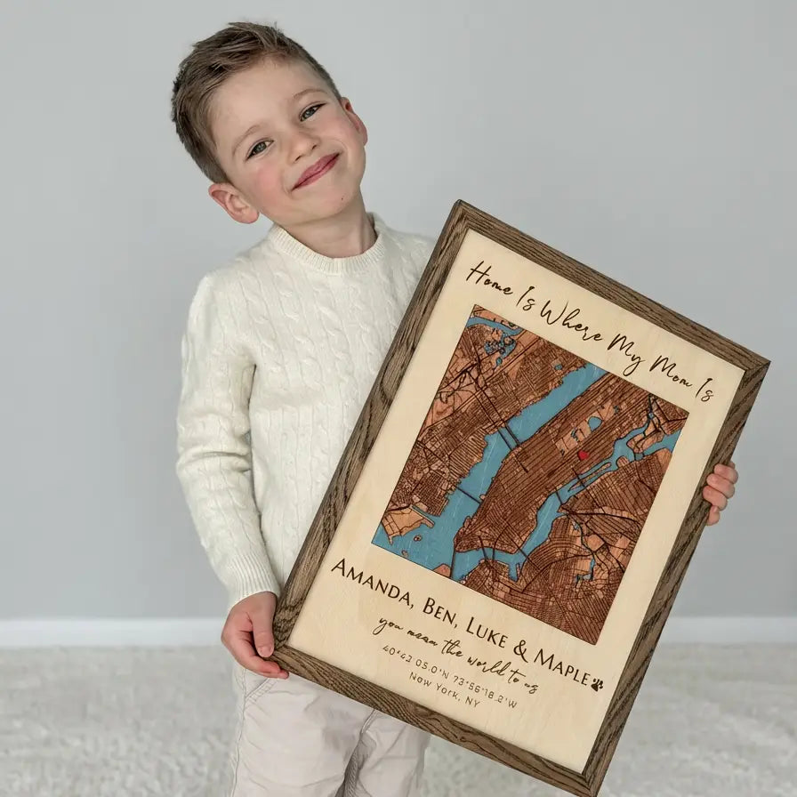 Child holding personalized custom location wood map frame gift for mom with engraved names and map  