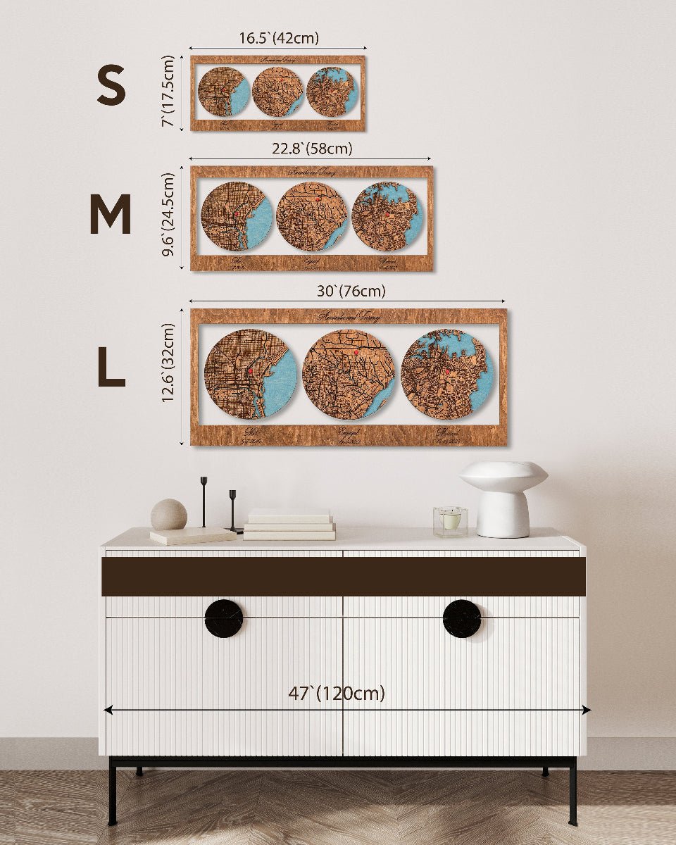 Wooden wall art with three circular designs on a white wall, below which is a white cabinet with black accents.