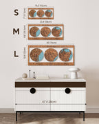 Wooden wall art with three circular designs on a white wall, below which is a white cabinet with black accents.