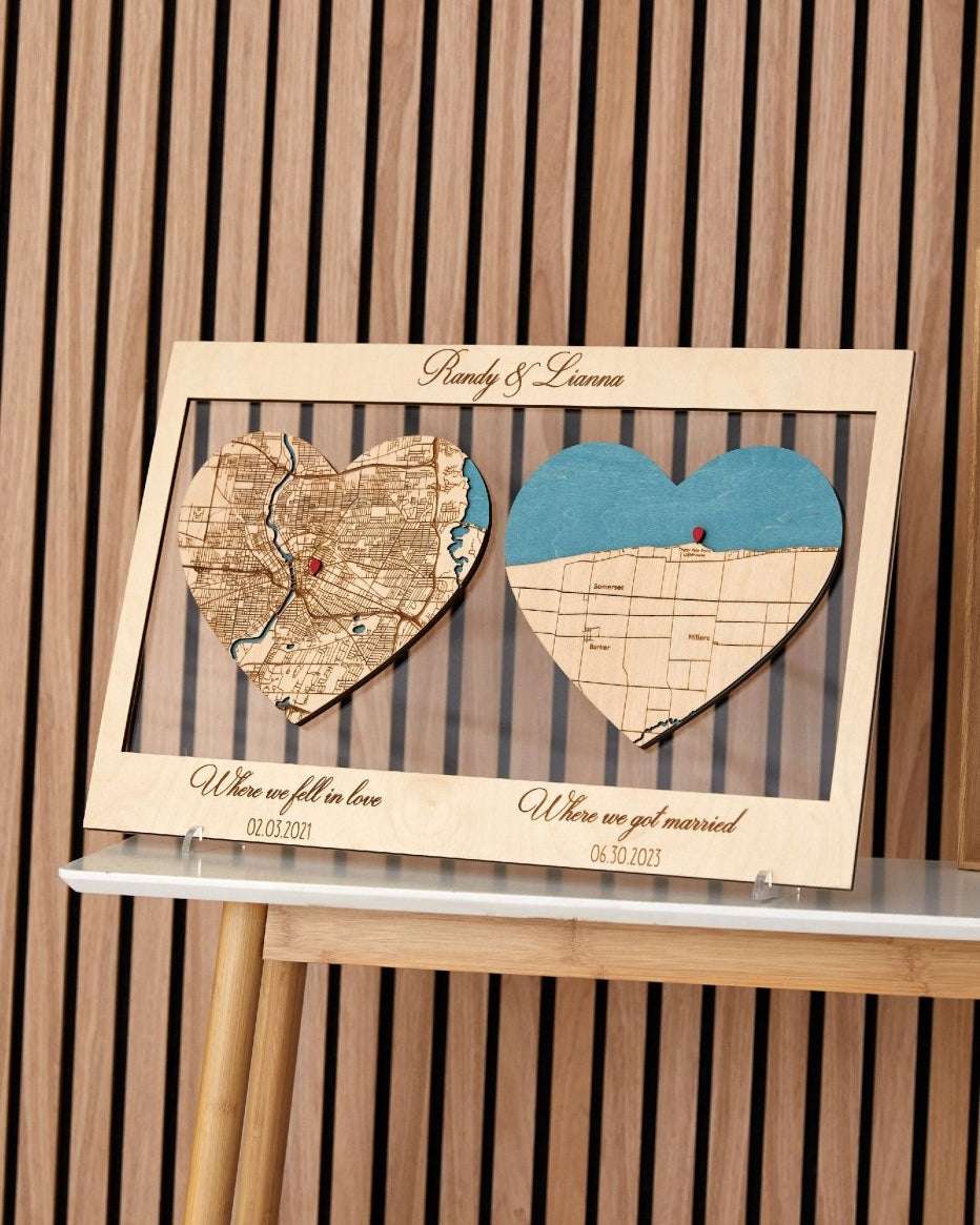 Wooden heart-shaped map display with engraved text on a wooden stand.