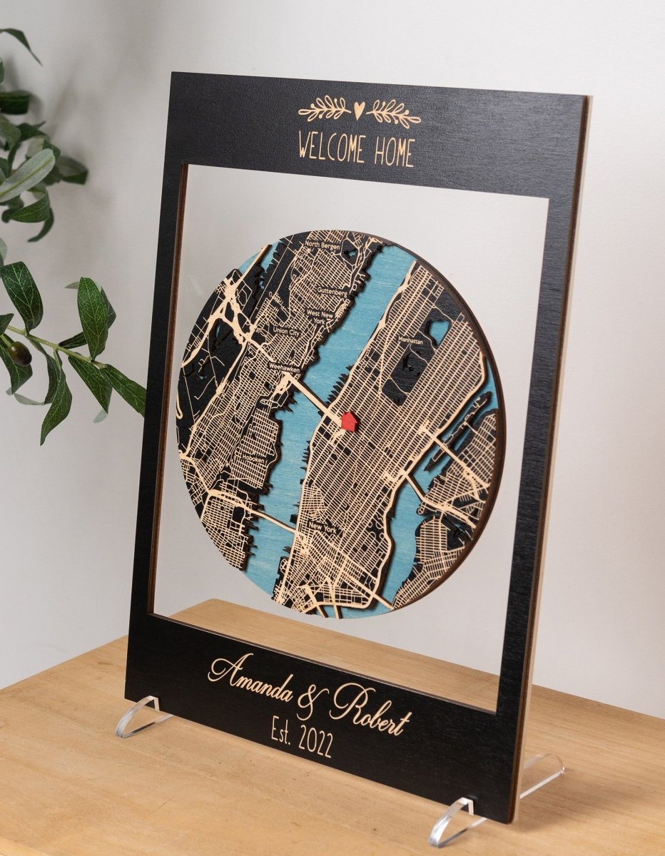 Personalized map art piece with 'Welcome Home' text on a stand.