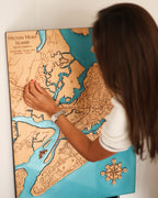 Person looking at a detailed map of Hilton Head Island on a wall.