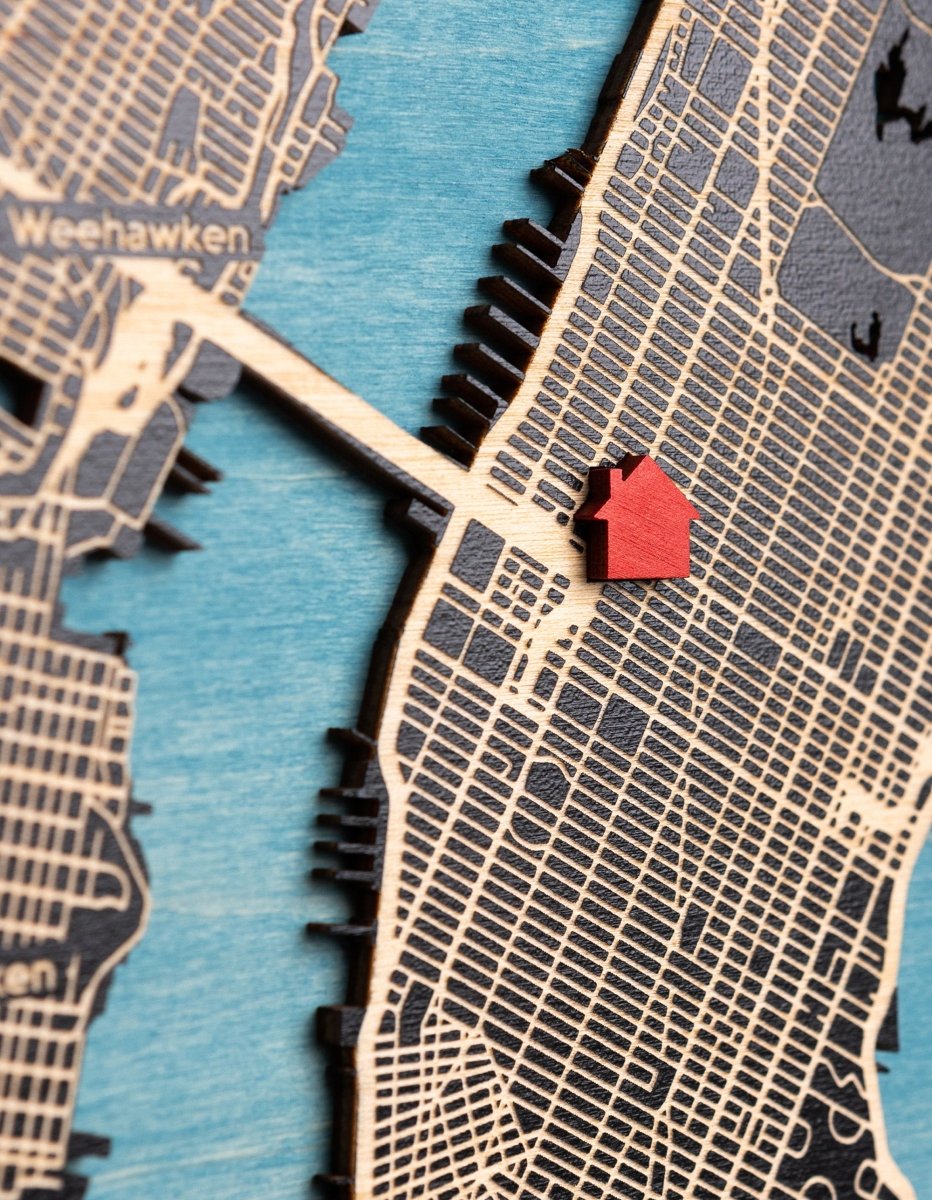 Map of a city with a red house icon on a blue and gray background