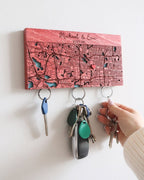 Key holder with a map design and personalized text, holding keys against a white background.