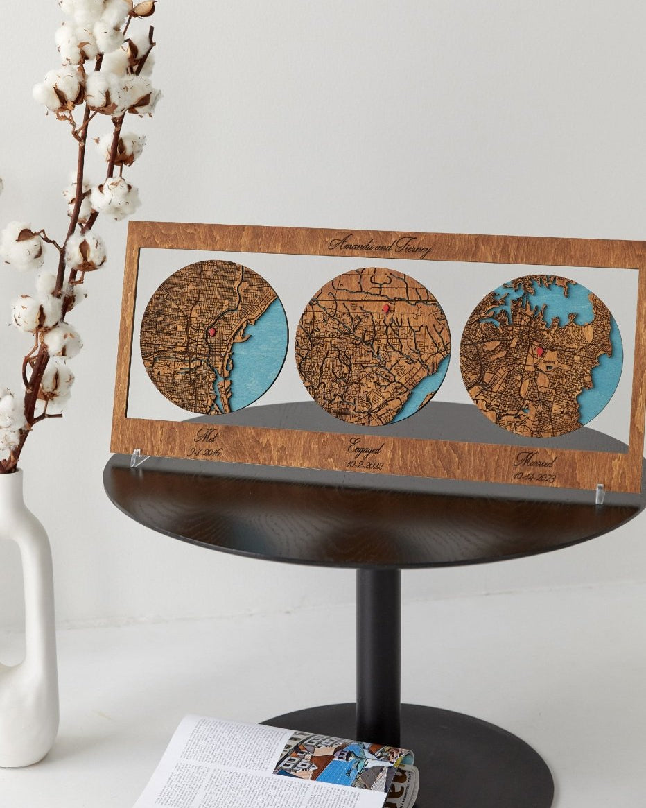 Wooden map display with three circular maps on a small round table.
