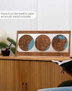 Wooden wall art with three circular designs on a shelf next to a person reading a book.