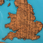 Close up detail of epoxy resin ocean and wood grain on London map
