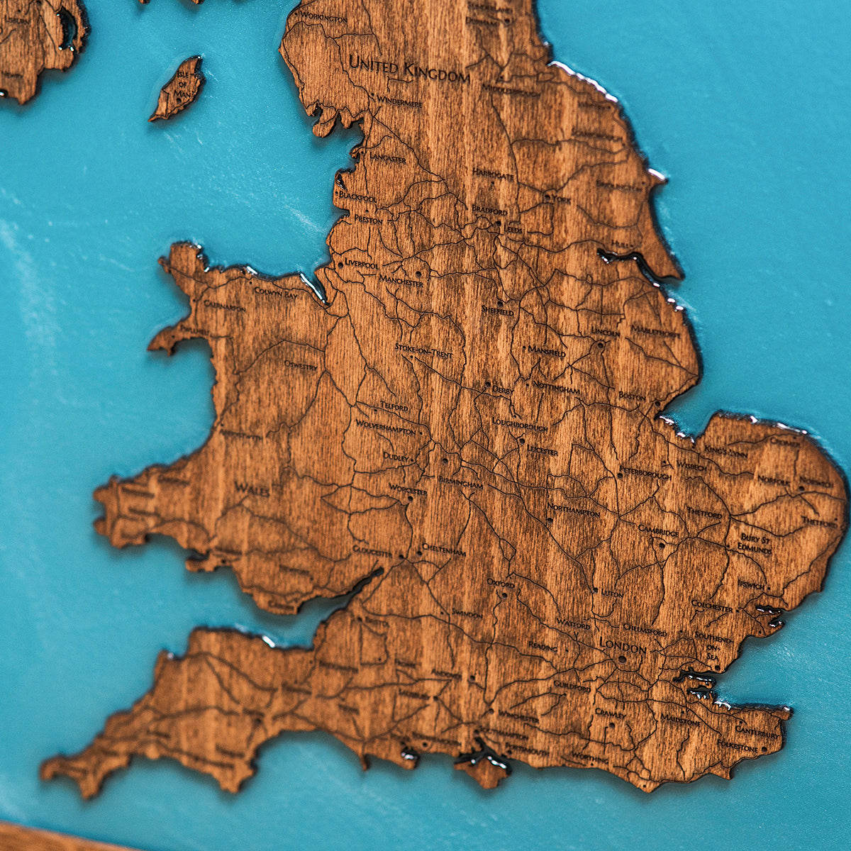 Close up detail of epoxy resin ocean and wood grain on London map
