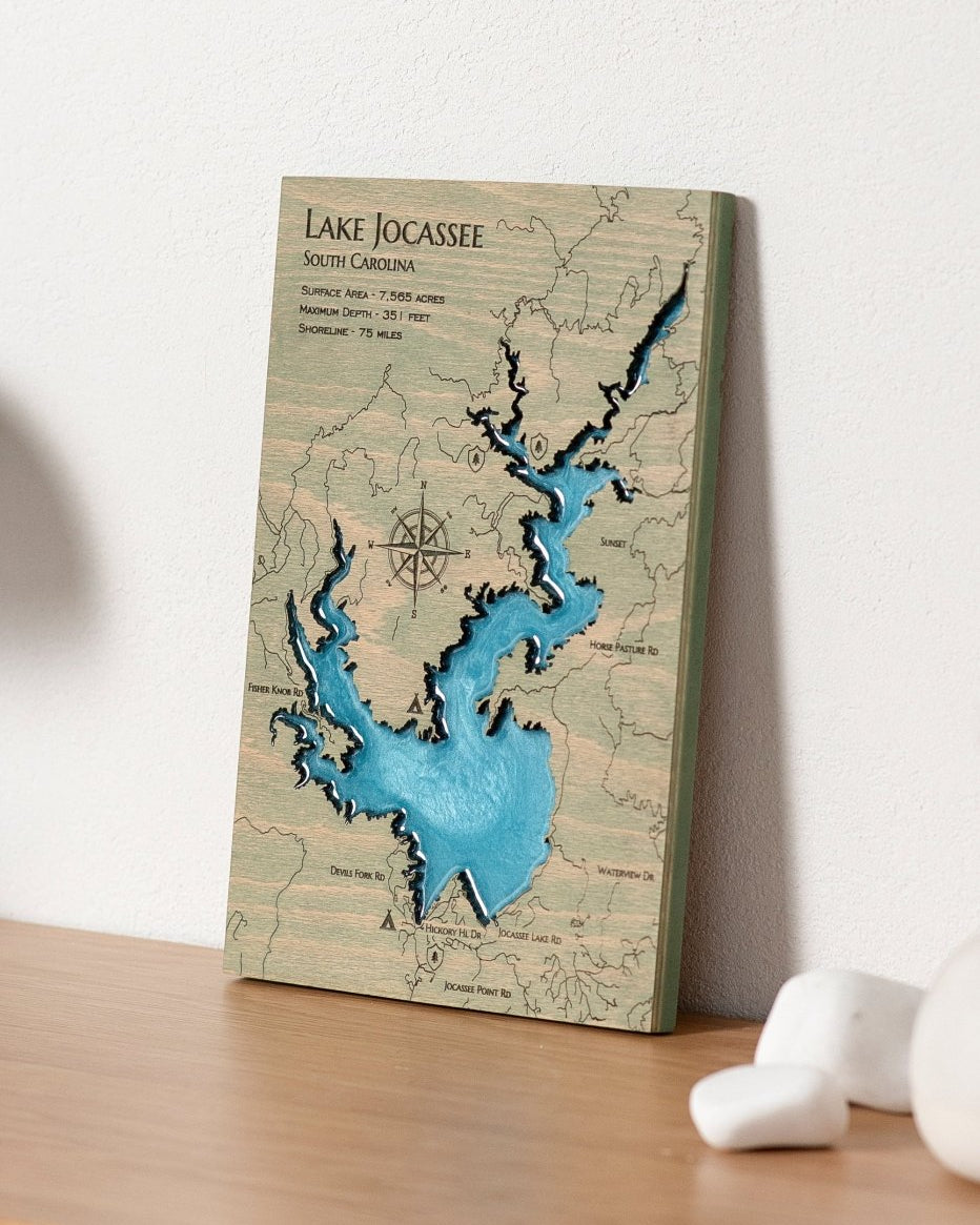 Wooden map of Lake Jocassee on a wooden surface with a white background