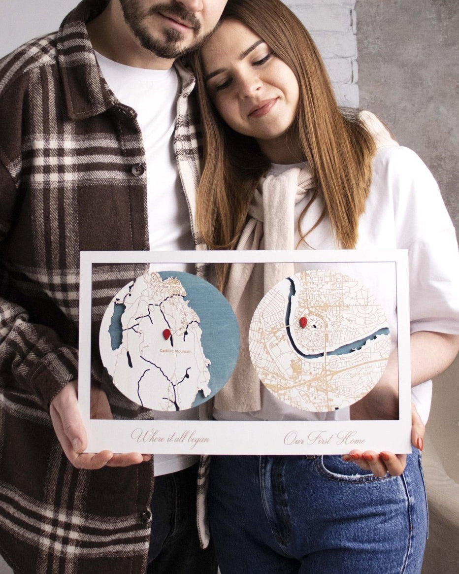 Man and woman holding a framed map of their first date together.