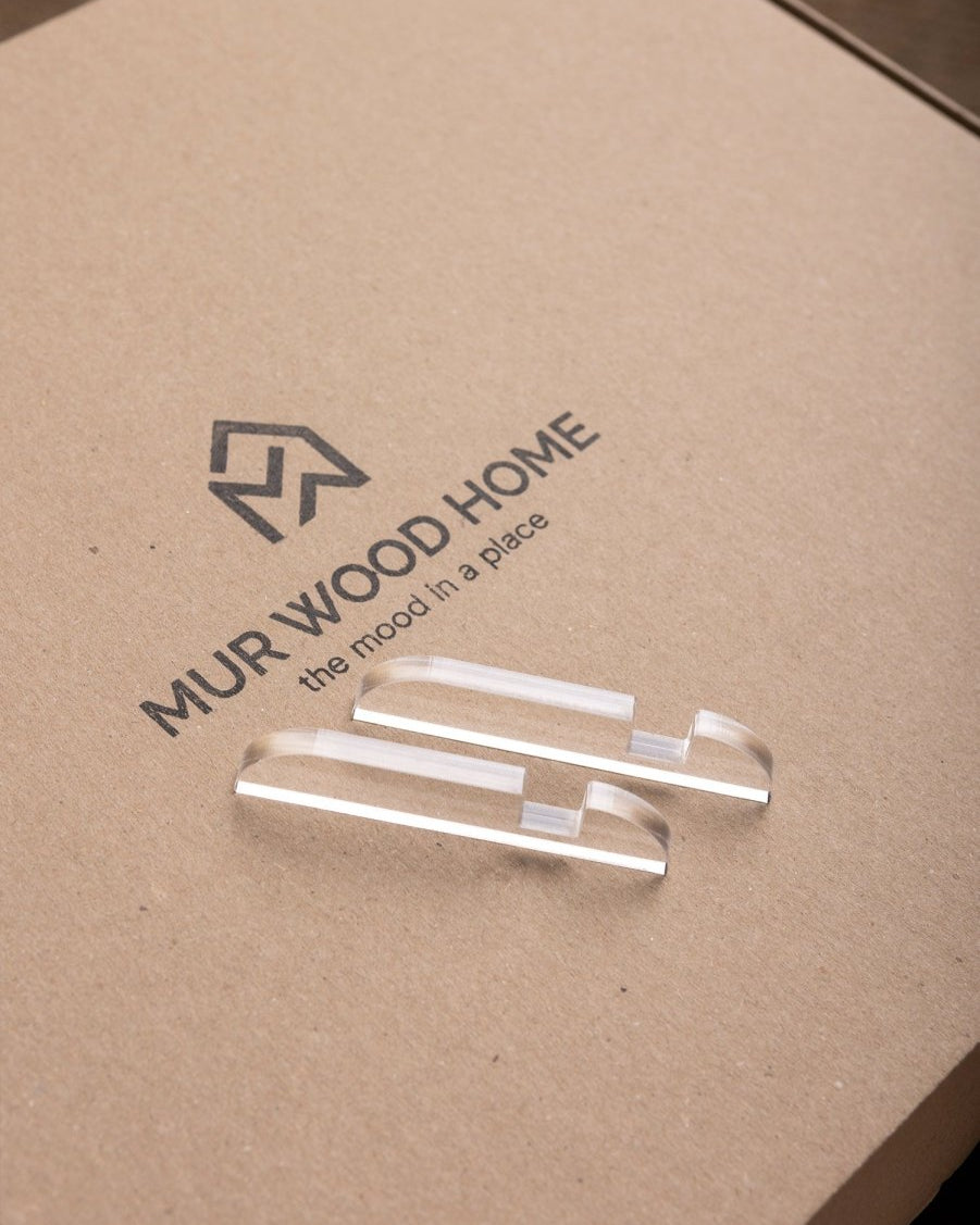 MUR WOOD HOME logo on a cardboard surface with clear acrylic samples.