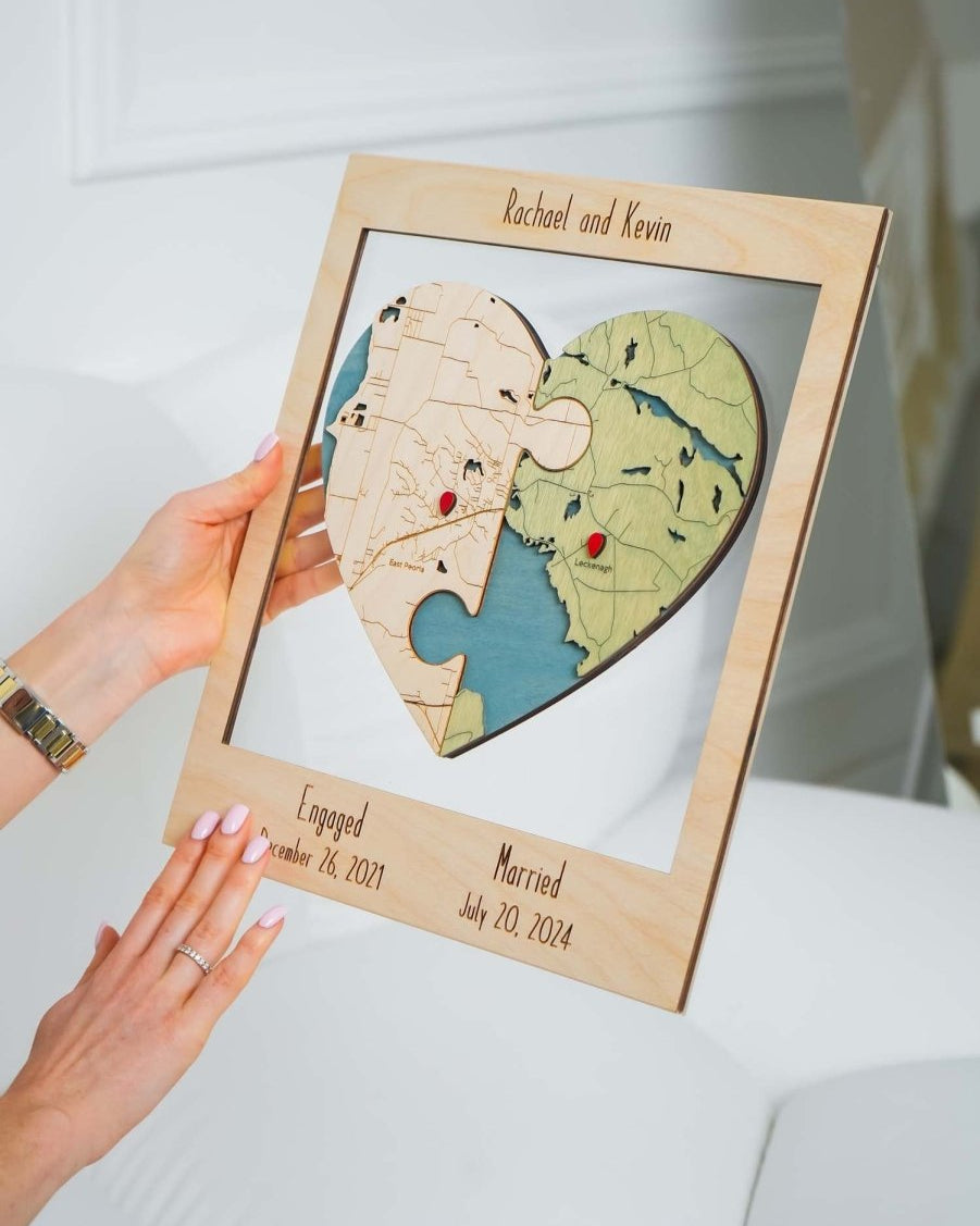 Heart-shaped puzzle with engraved names and dates in a wooden frame.