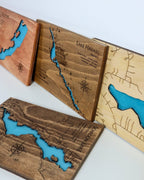 Wooden map of Lake Havasu with blue water features on a white background