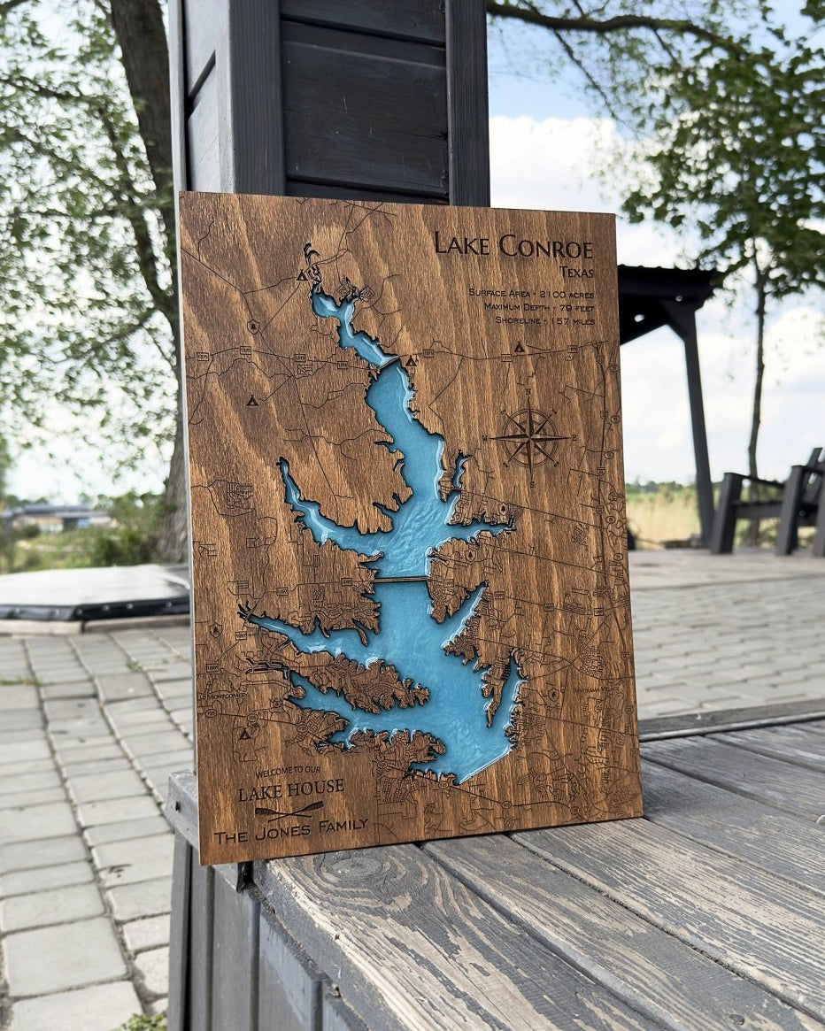 Wooden lake map with blue water inset on a wooden surface outdoors