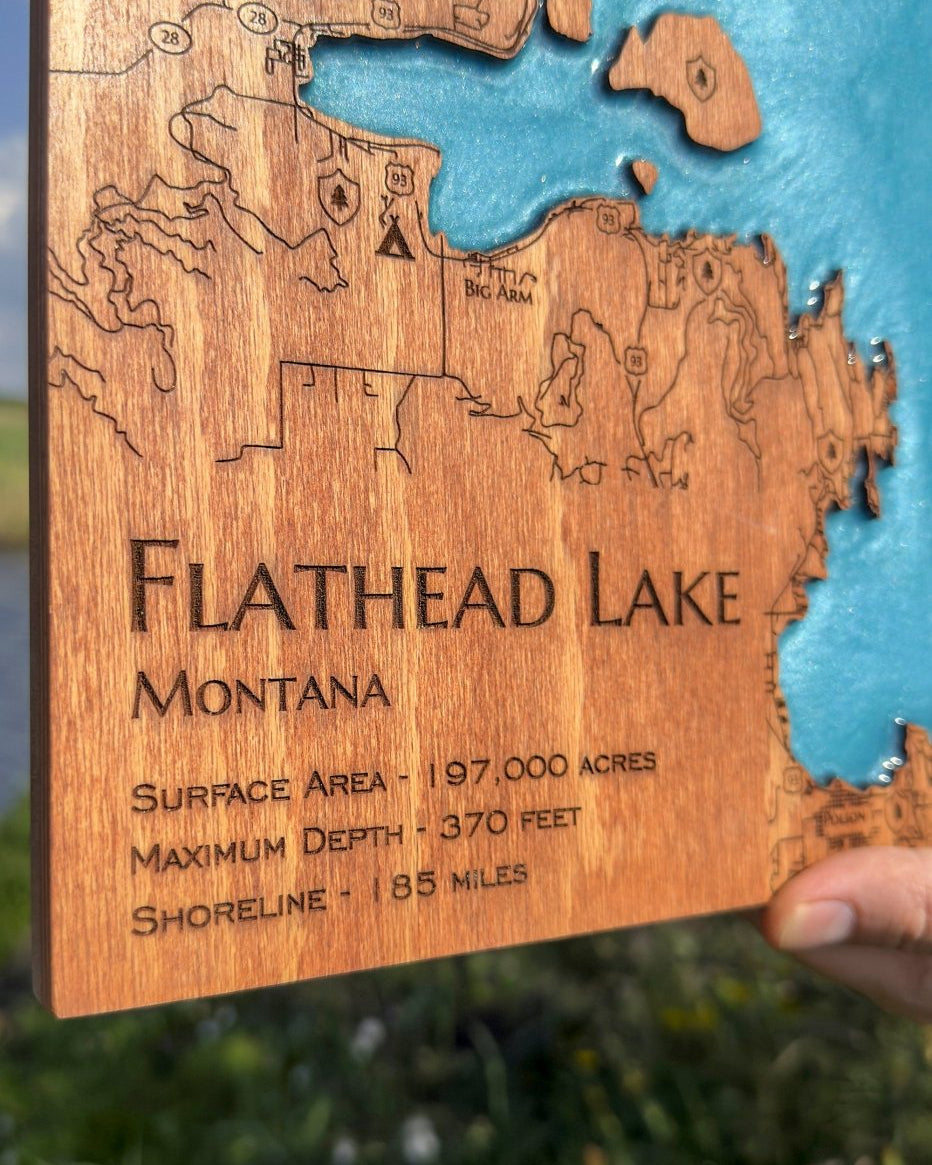 Wooden map of Flathead Lake, Montana with laser-etched details.