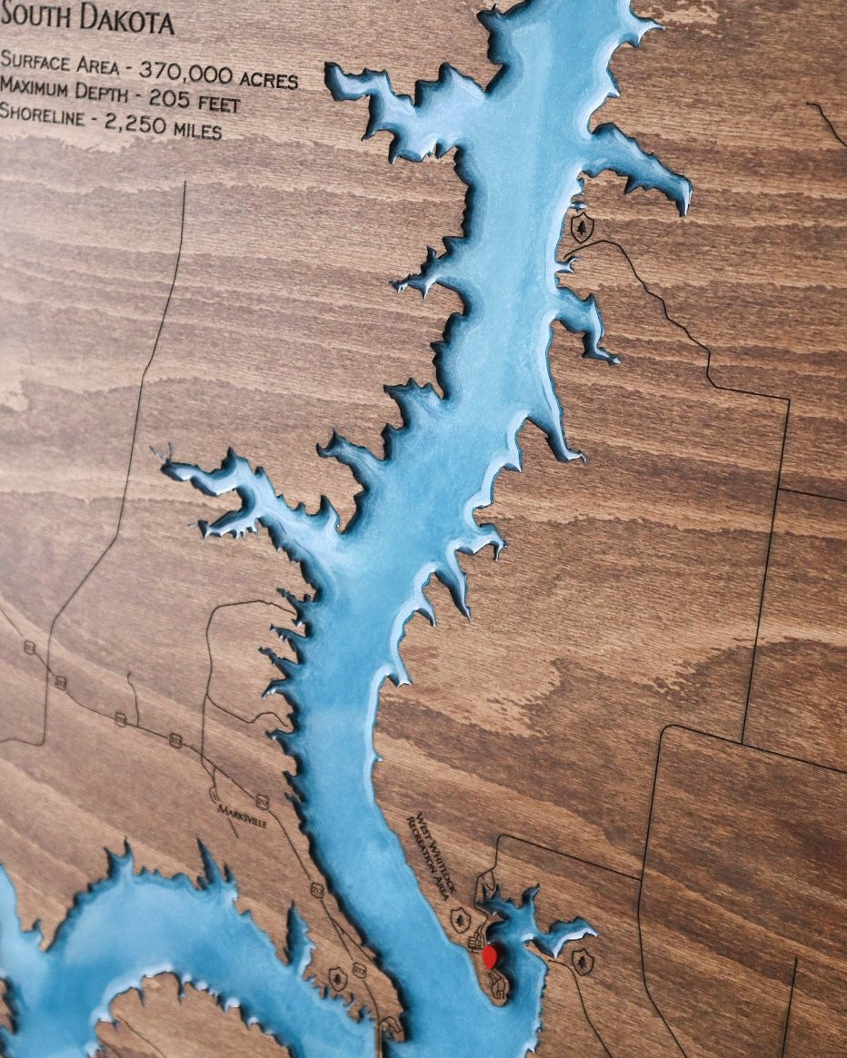 Wooden map of South Dakota with a focus on waterways
