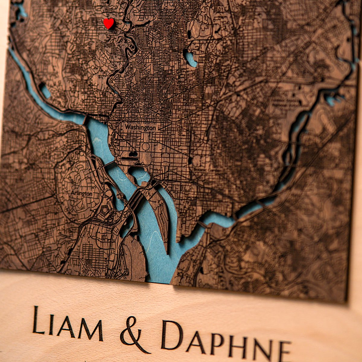 Close-up of layered 3D wooden city map with detailed streets and landmarks
