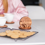 Close up of custom wooden coasters with engraved map design and matching holder personalized gift set