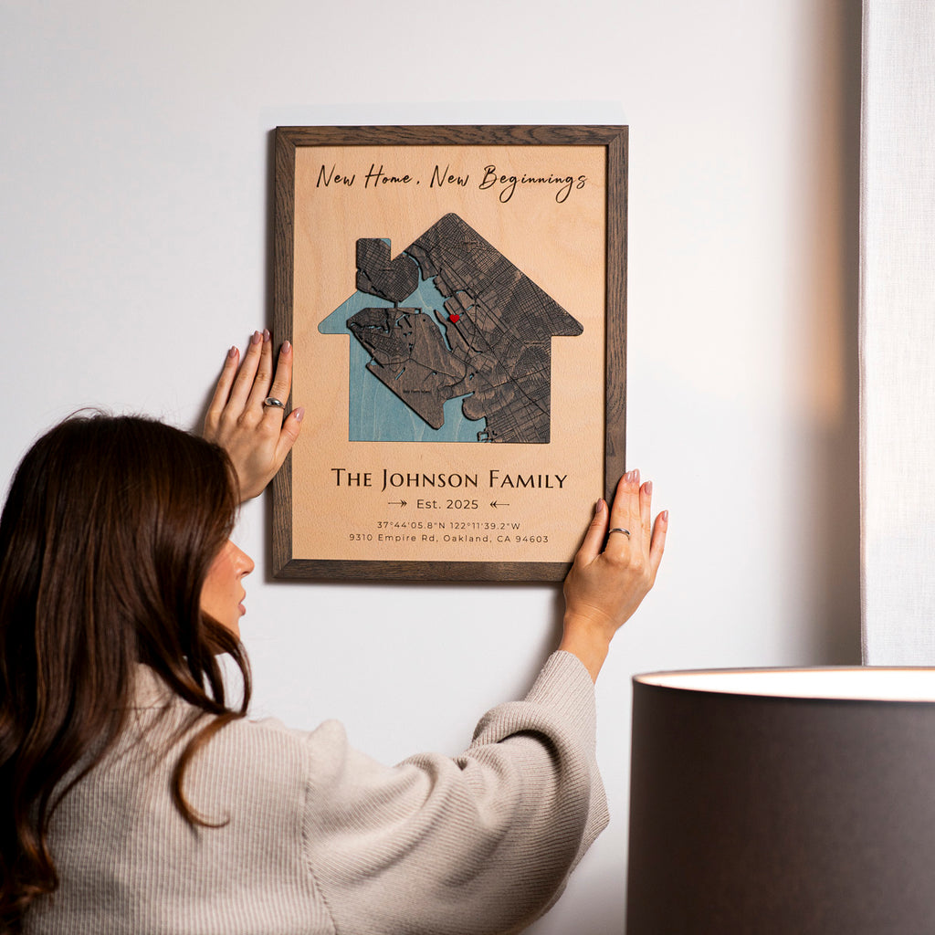 Personalized first home map hanging in modern living room interior housewarming gift idea.