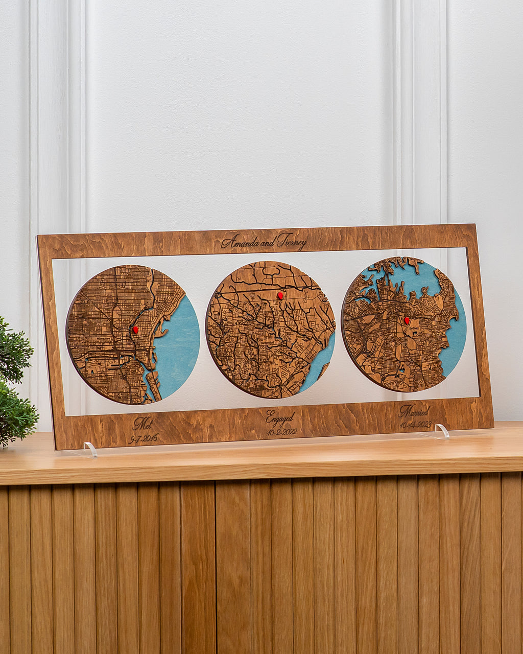 Wooden map display with three circular maps on a wooden shelf.