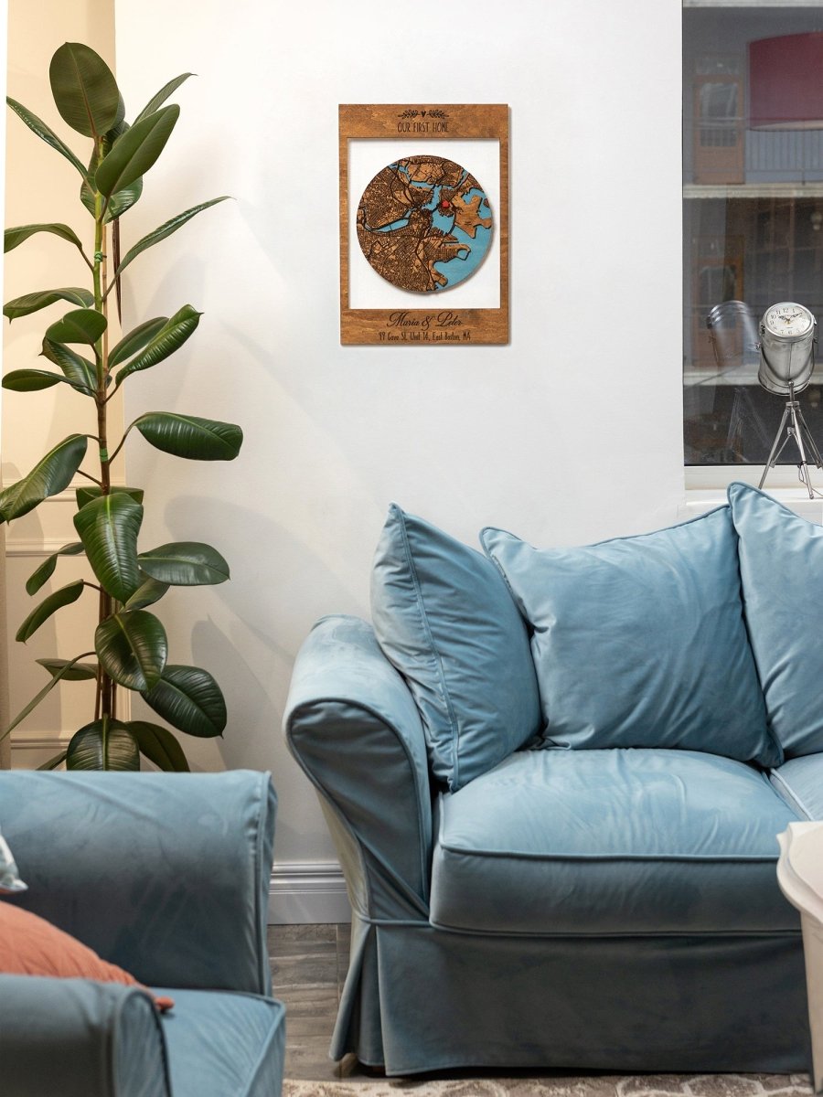 Living room with blue sofa, plant, and decorative wall piece.