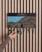 Key holder with personalized map design on a wooden wall.