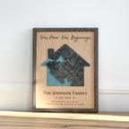 Framed artwork with house and heart design, text 'New Home, New Beginning' and 'The Johnson Family Est. 2025' on a light background.