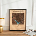 Framed map print with personalized text on a wooden surface.