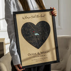Person holding heart-shaped personalized wood map frame with “Where we tied the knot,” couple names, wedding date, and coordinates.