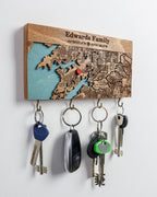 Key holder with engraved map design and custom text and coordinates on a white background