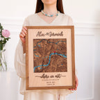 Woman holding a personalized wooden couple map with raised 3D names, custom London location, coordinates, date, and natural oak frame.