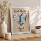 Personalized 3D wooden engagement map in white frame displayed on a wooden shelf with candles, flowers, and warm minimalist home decor.
