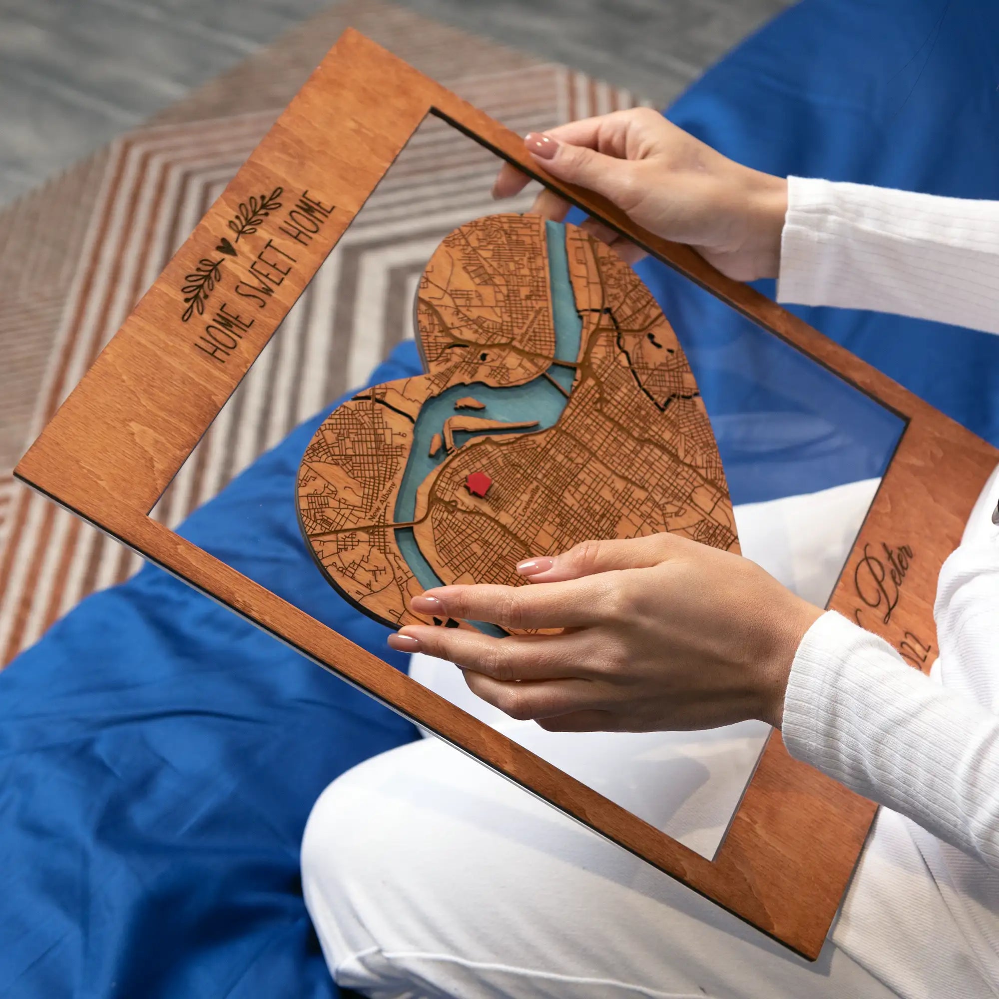 Hands holding Personalized New Home Map wooden keepsake with heart city map inside custom engraved wooden frame