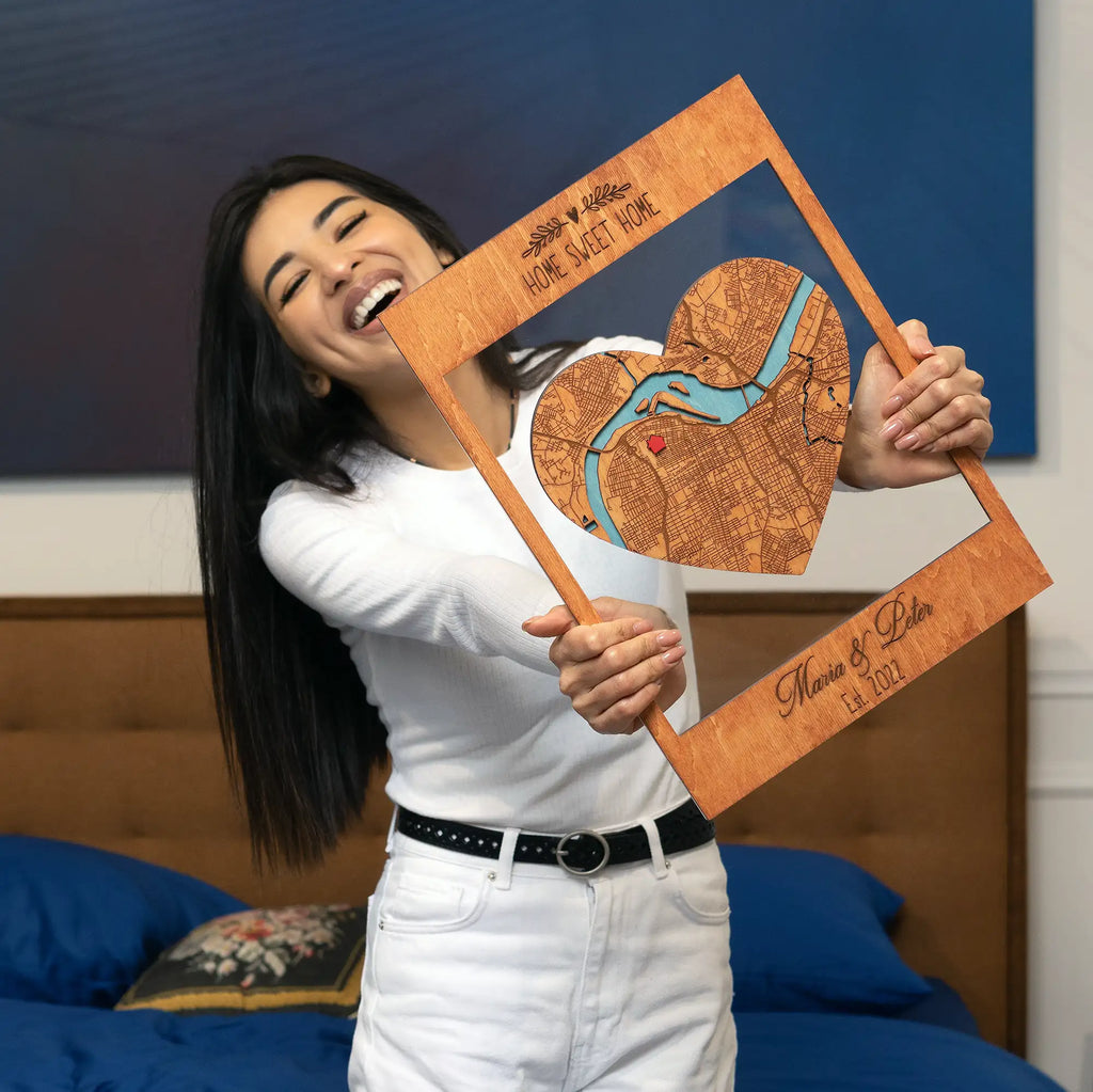 Woman holding Personalized New Home Map wooden keepsake with heart-shaped map, custom names, and housewarming text