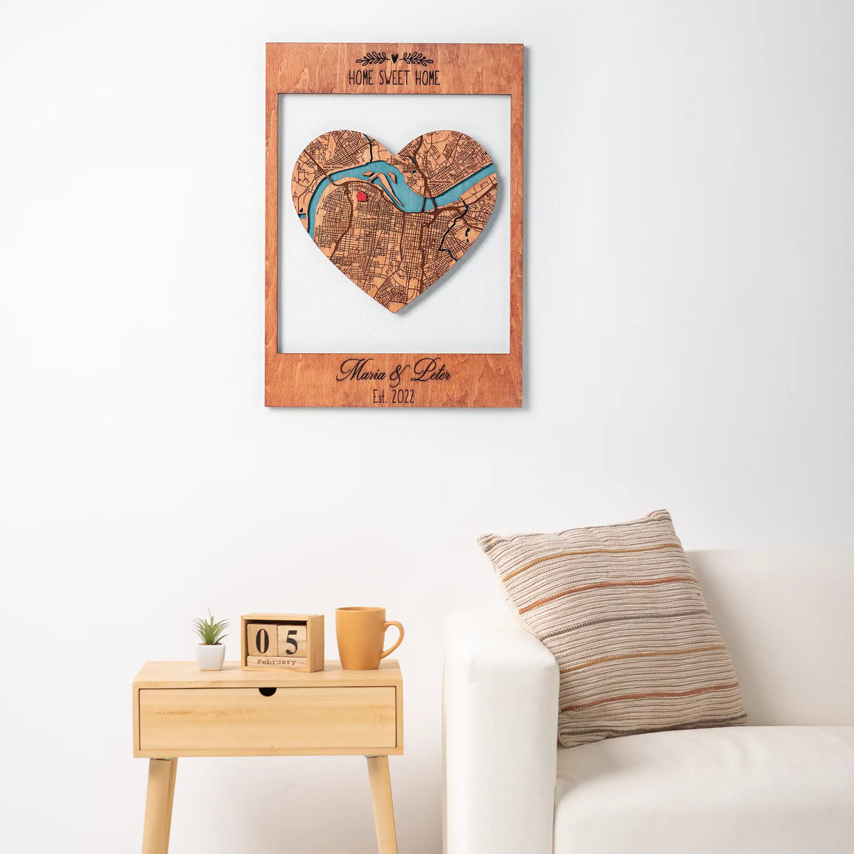 Personalized New Home Map wooden keepsake displayed on wall above side table as warm housewarming decor