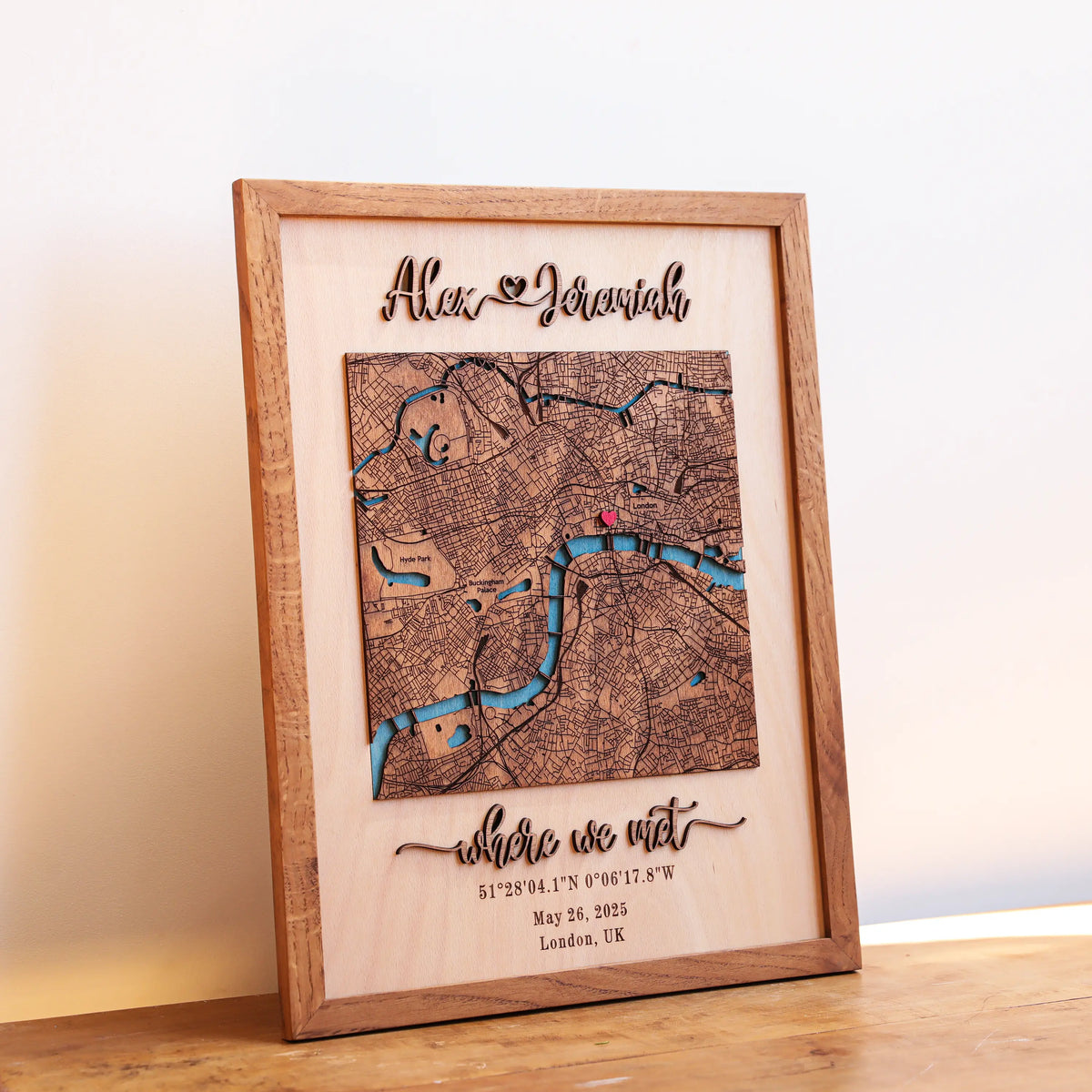 Personalized wooden Where We Met map in a natural oak frame with raised 3D names, custom London location, coordinates, and date.