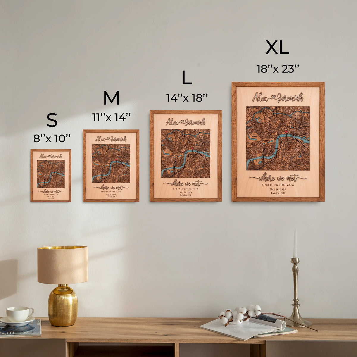 Size comparison chart for personalized wooden map wall art showing S 8x10, M 11x14, L 14x18, and XL 18x23 framed options displayed on a wall.