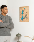 Man standing in a room with a wooden map of Smithville Lake on the wall.