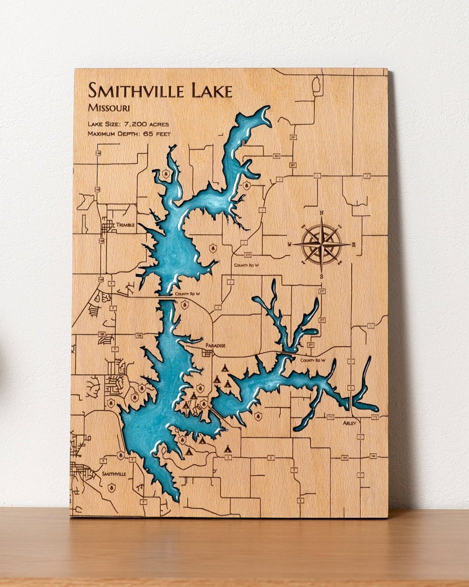 Wooden map of Smithville Lake with blue water feature on a white background
