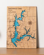 Wooden map of Smithville Lake with blue water feature on a white background