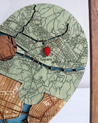 Map of Tuscany with a red pin on a wooden board