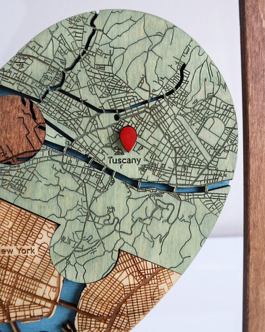 Map of Tuscany with a red pin on a wooden board