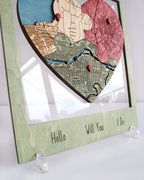 Heart-shaped map design with 'Hello Will You Do' text on a stand