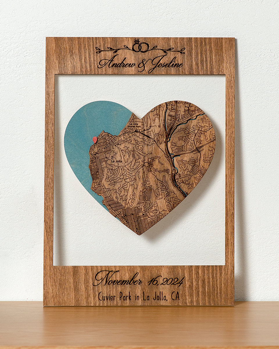 Wooden heart-shaped map with engraved details on a white background