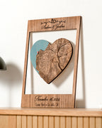 Wooden frame with heart-shaped cutout featuring a map, on a white background