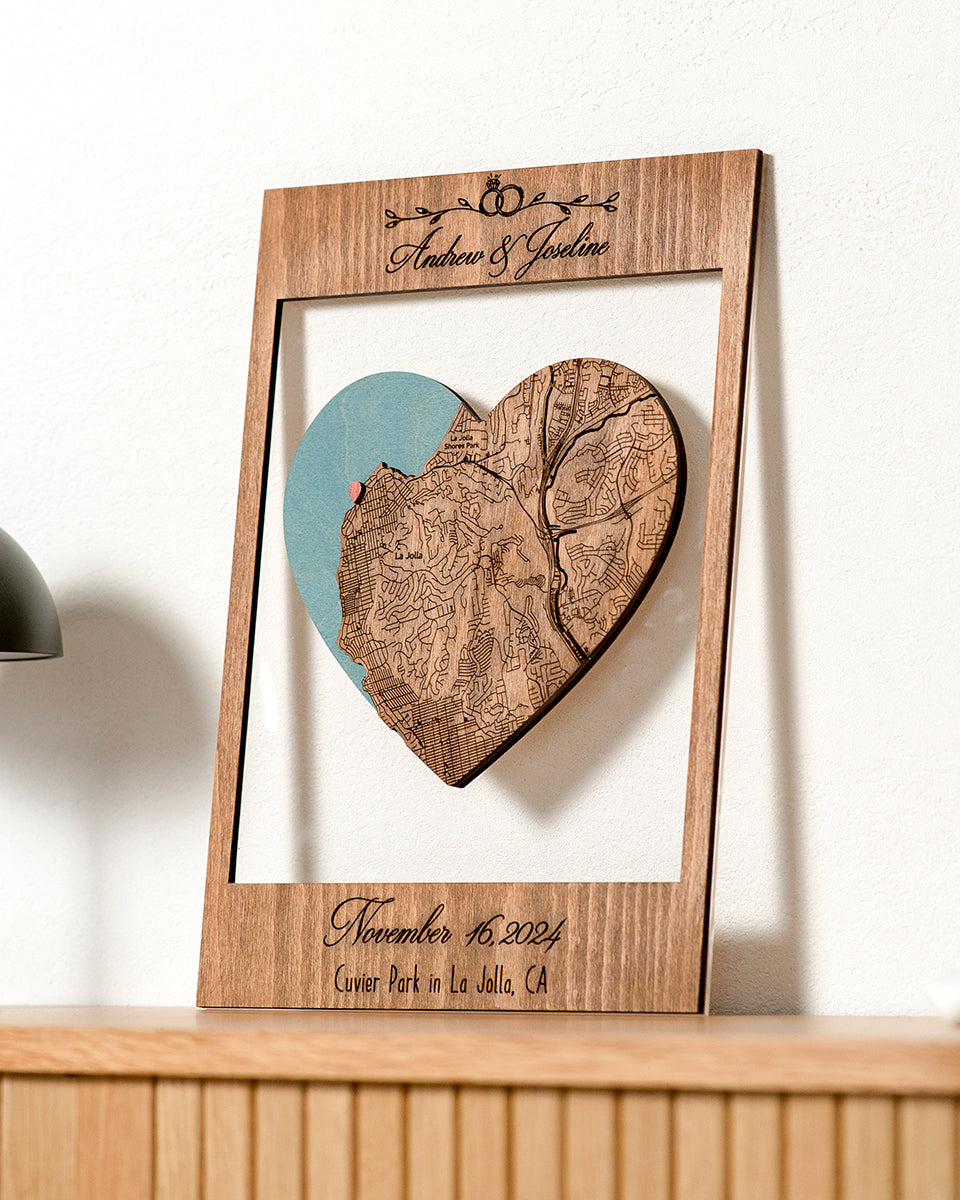 Wooden frame with heart-shaped cutout featuring a map, on a white background