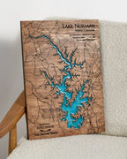 Wooden map of Lake Norman, North Carolina, with blue water inset, on a white surface.