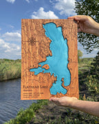 Wooden  map of Flathead Lake held in front of the lake
